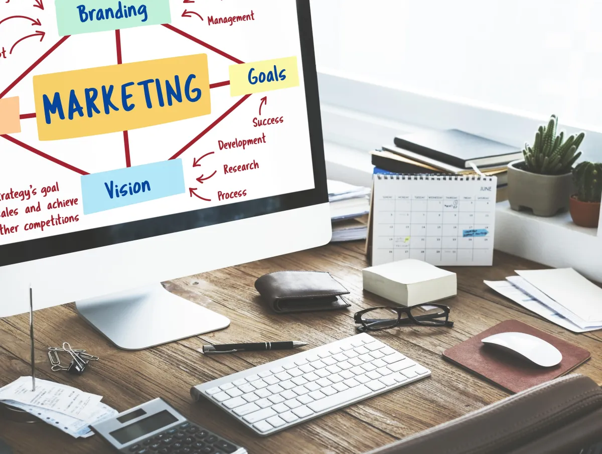 Desk with a monitor showing a marketing strategy mind map