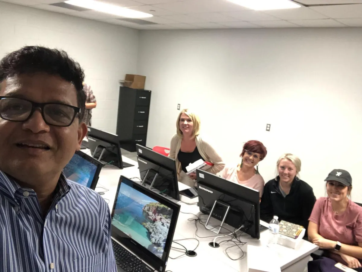 Vizipp team member with teachers at a computer lab workshop