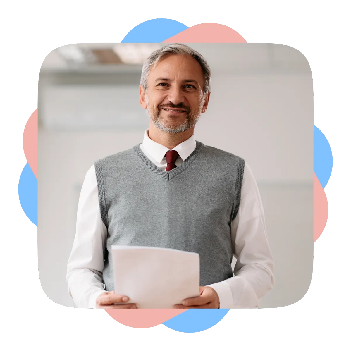 Smiling teacher holding papers in a school hallway